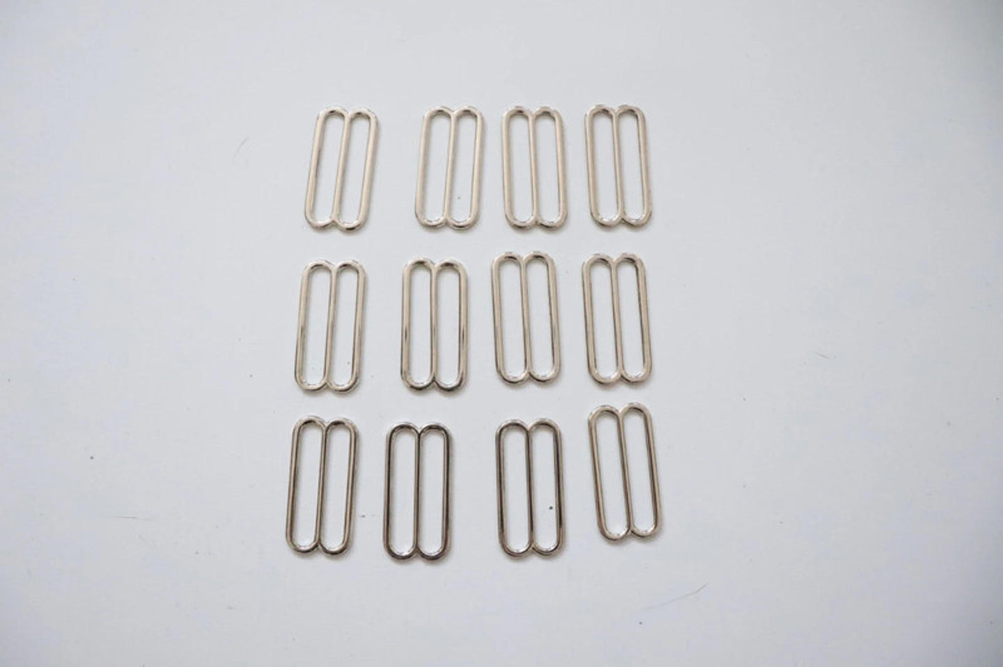 LOT #106 - silver chunky adjusters, bag making accessory