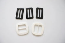 LOT #109 - 3 black and 2 white chunky adjusters, bag making accessory