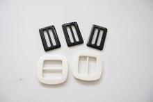 LOT #109 - 3 black and 2 white chunky adjusters, bag making accessory