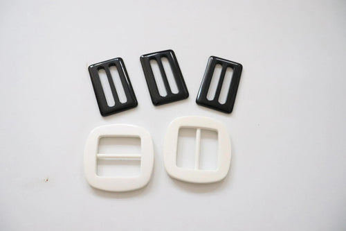 LOT #109 - 3 black and 2 white chunky adjusters, bag making accessory