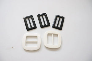 LOT #109 - 3 black and 2 white chunky adjusters, bag making accessory