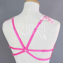 Bright pink floral lace body harness with pink adjustable elastic straps with silver metal rings and sliders