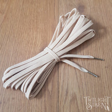Beige polyester lacing for corsets stays or shoes with the ends finished with metal aglets